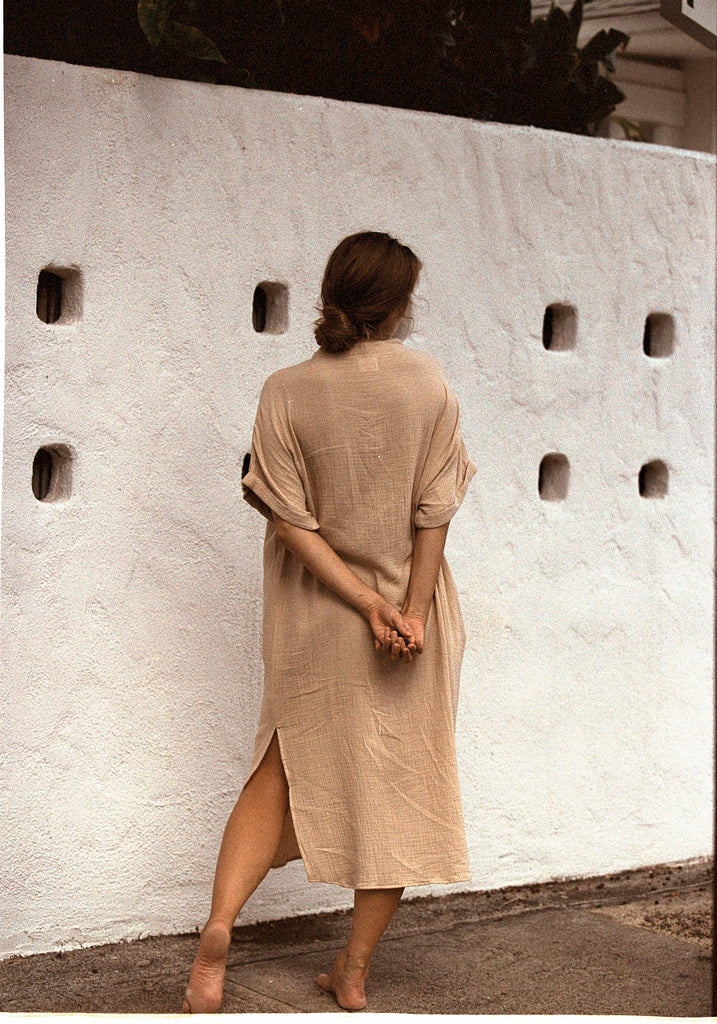 Tan loose-fitting dress with v-neck back view